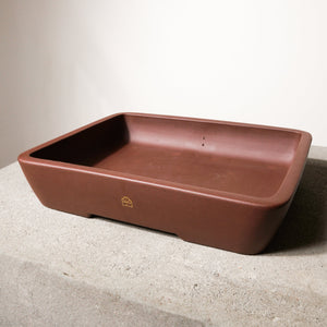 14" wide Xiying clay bonsai pot on a concrete surface with a neutral background.