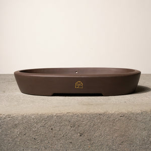 14" wide Xiying clay bonsai pot on a concrete surface with a neutral background.