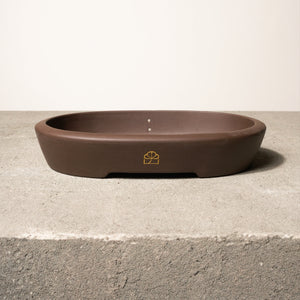 12" wide Xiying clay bonsai pot on a concrete surface with a neutral background.