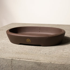 12" wide Xiying clay bonsai pot on a concrete surface with a neutral background.