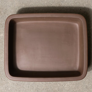12" wide Xiying clay bonsai pot on a concrete surface with a neutral background.